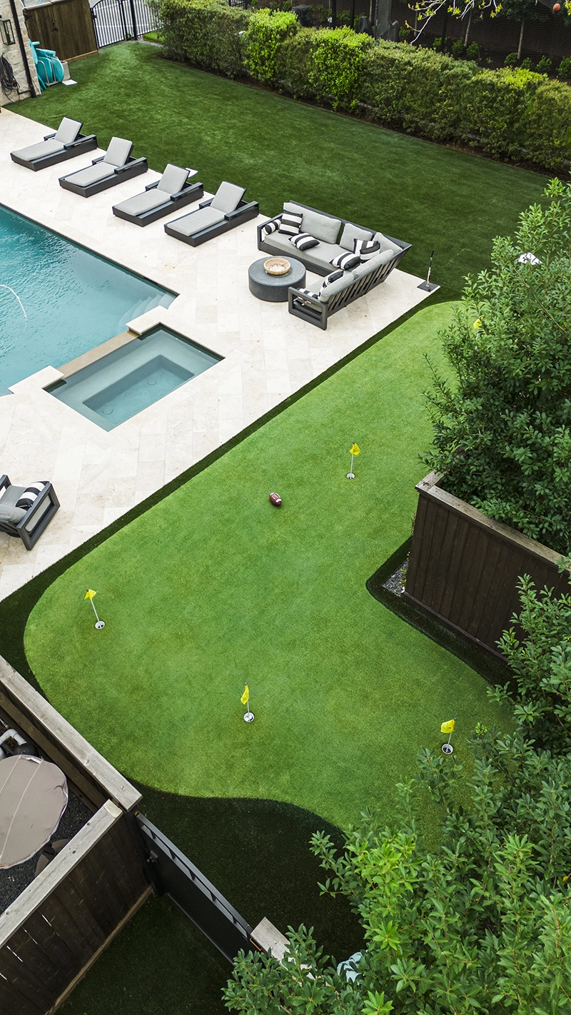 Residential pool and putting green installation with custom landscape architecture and outdoor living design.