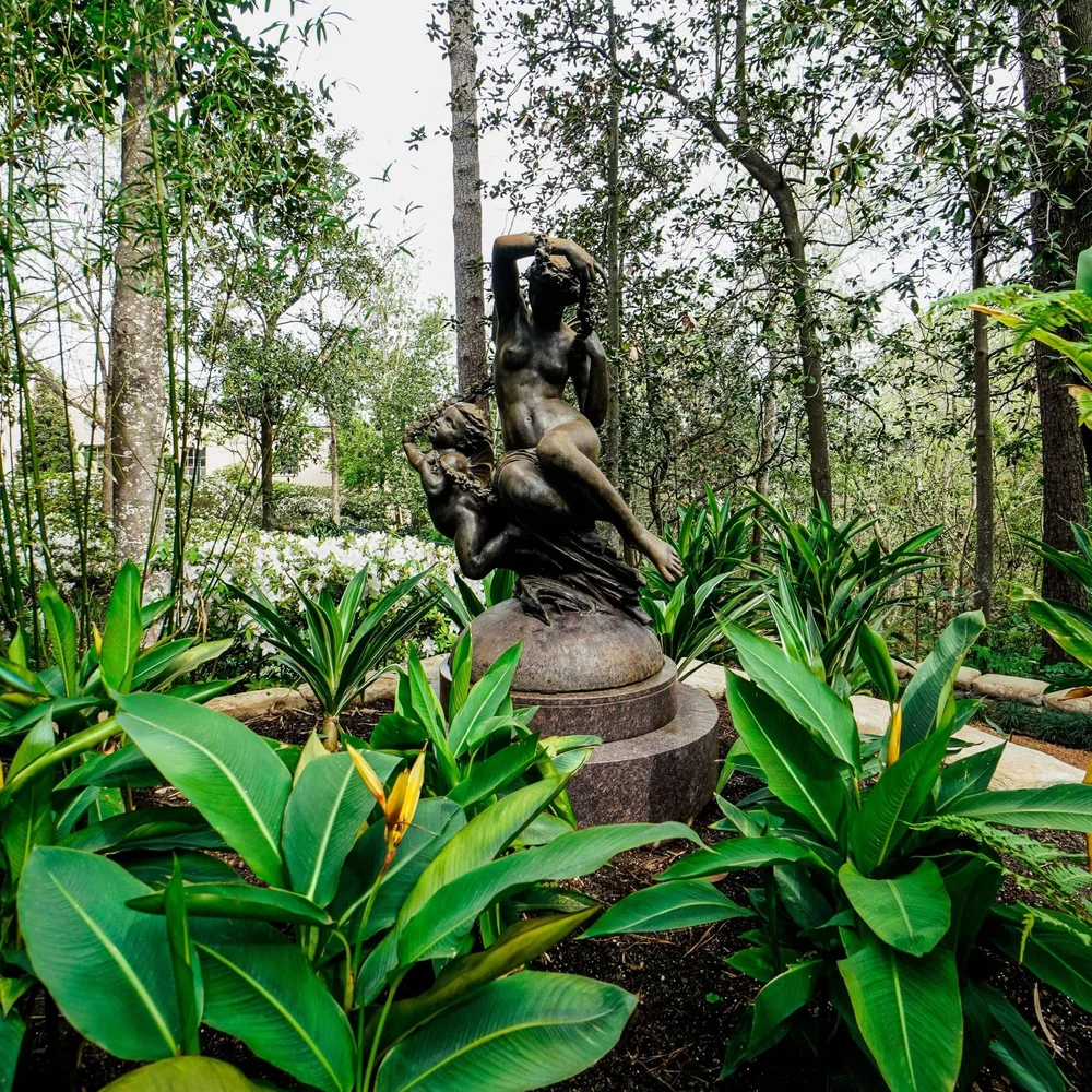 Landscape installation at Rienzi, Museum of Fine Arts, Houston featuring tropical plantings and classical garden sculpture