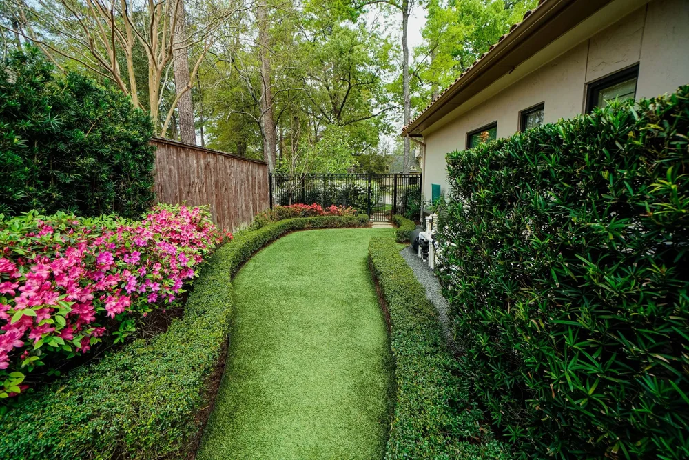 Contemporary estate, River Oaks — architecture-led planting design, motorized gate surround, and smart lighting integration.