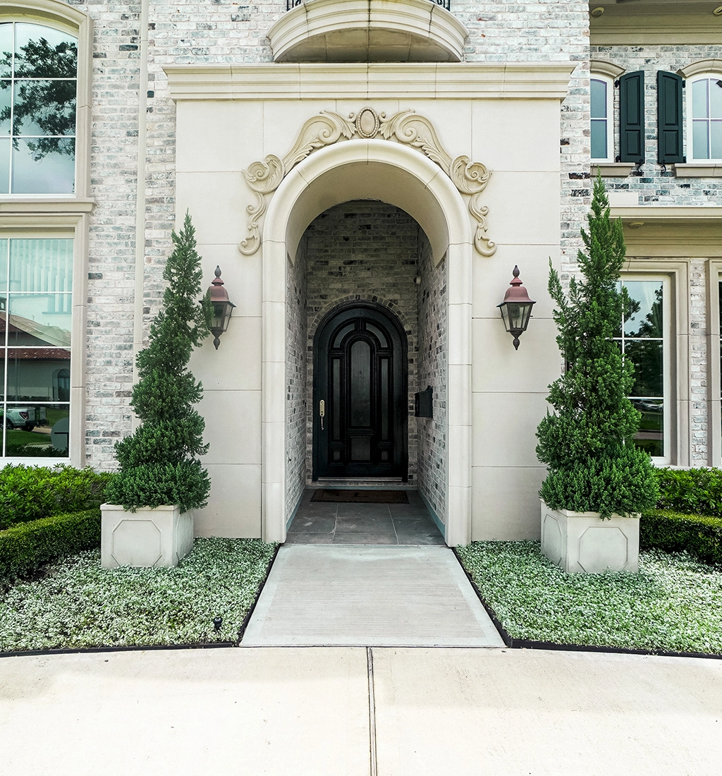 Spanish Colonial renovation, Lazy Lane — complete landscape replacement following home reconstruction. Drainage regraded, new irrigation, formal courtyard planting.